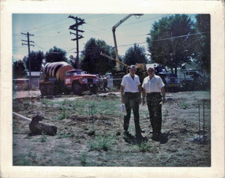 Bill and an unnamed gentleman ready to pour concrete